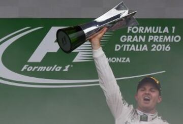 Winner Mercedes AMG Petronas F1 Team's German driver Nico Rosberg holds his trophy as he celebrates on the podium following the Italian Formula One Grand Prix at the Autodromo Nazionale circuit in Monza on September 4, 2016.