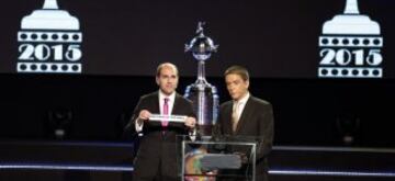 President of Chile's Football Federation Sergio Jadue (L) holds up a piece of paper with the name of Venezuela 's soccer team Sporting Deportivo Tachira during the draw for the 2015 Copa Libertadores at the South American Football Confederation (CONMEBOL) headquarters in Luque, on the outskirts Asuncion, December 2, 2014. REUTERS/Jorge Adorno (PARAGUAY - Tags: SPORT SOCCER)