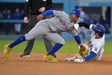 Oct 13, 2024; Los Angeles, California, USA; New York Mets shortstop Francisco Lindor (12) gets the tag on Los Angeles Dodgers two-way player Shohei Ohtani (17) attempting to steal second base in the second inning during game one of the NLCS for the 2024 MLB Playoffs at Dodger Stadium. Mandatory Credit: Jayne Kamin-Oncea-Imagn Images