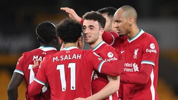 15 March 2021, United Kingdom, Wolverhampton: Liverpool&#039;s Diogo Jota celebrates scoring his side&#039;s first goal with teammates during the English Premier League soccer match between Wolverhampton Wanderers and Liverpool at Molineux Stadium. Photo: