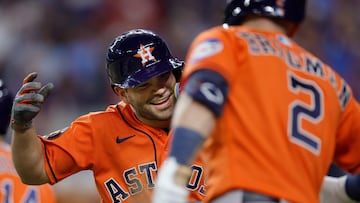 ARLINGTON, TEXAS - OCTOBER 19: Jose Altuve #27 and Mauricio Dub�n #14 of the Houston Astros celebrate after Altuve scored a run in the eighth inning against the Texas Rangers during Game Four of the Championship Series at Globe Life Field on October 19, 2023 in Arlington, Texas. Carmen Mandato/Getty Images/AFP (Photo by Carmen Mandato / GETTY IMAGES NORTH AMERICA / Getty Images via AFP)