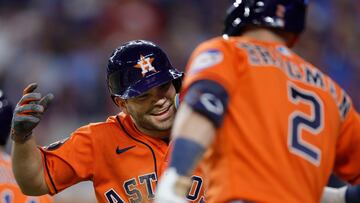 ARLINGTON, TEXAS - OCTOBER 19: Jose Altuve #27 and Mauricio Dub�n #14 of the Houston Astros celebrate after Altuve scored a run in the eighth inning against the Texas Rangers during Game Four of the Championship Series at Globe Life Field on October 19, 2023 in Arlington, Texas.   Carmen Mandato/Getty Images/AFP (Photo by Carmen Mandato / GETTY IMAGES NORTH AMERICA / Getty Images via AFP)