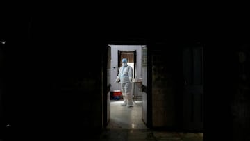 A health worker in personal protective equipment (PPE) waits at a local health centre for the next person to be tested for the coronavirus disease (COVID-19), amid the spread of the disease, in the old quarters of Delhi, India, August 14, 2020. REUTERS/Ad