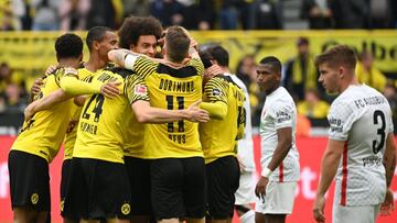 Dortmund&#039;s players celebrate the 2-1 goal scored by Dortmund&#039;s German forward Julian Brandt (hidden) as Augsburg&#039;s Danish defender Mads Pedersen (R) looks on during the German first division Bundesliga football match between Borussia Dortmu