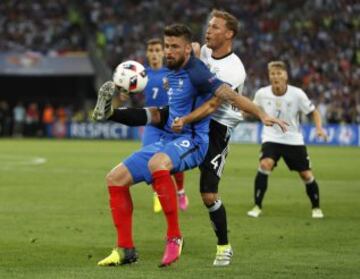 Olivier Giroud holds off Germany defender Benedikt Howedes.