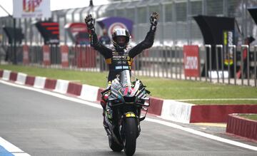 Marco Bezzecchi celebra con los brazos en alto, sin sujetar el manillar de su moto, su victoria en el GP de India.