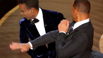 FILE PHOTO: Will Smith (R) hits Chris Rock as Rock spoke on stage during the 94th Academy Awards in Hollywood, Los Angeles, California, U.S., March 27, 2022. REUTERS/Brian Snyder/File Photo