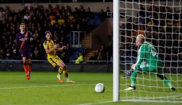 Manchester City's Phil Foden scores the team's third goal against Oxford.