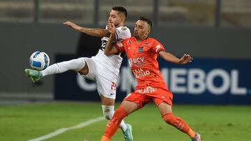 Paraguay&#039;s Olimpia Victor Salazar (L) and Peru&#039;s Cesar Vallejo Patricio Arce vie for the ball during their Copa Libertadores football match at the Nacional stadium in Lima, on February 9, 2022. (Photo by Cris BOURONCLE / AFP)