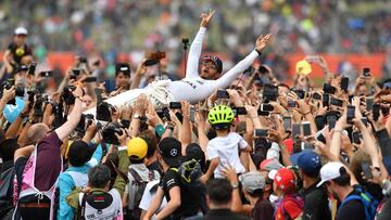 Winner Mercedes' British driver Lewis Hamilton is celebrated by fans after the British Formula One Grand Prix at the Silverstone motor racing circuit in Silverstone, central England on July 16, 2017. / AFP PHOTO / Ben STANSALL