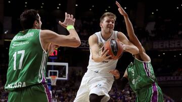 GRAF283. MADRID, 16/11/2017.- El base esloveno del Real Madrid, Luka Doncic, (c) intenta superar al pivot georgiano del Unicaja, Giorgi Shermadini (i), en partido de la octava jornada de la Euroliga que se disputa esta noche en el Wizink Center de Madrid. EFE/ Kiko Huesca