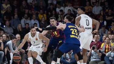 Facundo Campazzo, base del Real Madrid, trata de superar la defensa de los barcelonistas Tomas Satoransky y Tornike Shengelia durante el Clásico de la Euroliga.