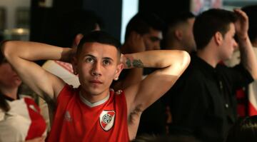 Argentina's River Plate team supporters react after their team lost 2-1 the Copa Libertadores football final against Brazil's Flamengo at a bar in Buenos Aires, on November 23, 2019. 