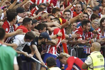 Carrasco celebrates his opener against Sevilla with Atlético fans at the Wanda Metropolitano