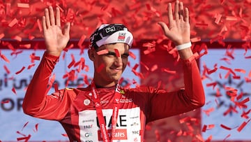 TOPSHOT - UAE Team Emirates's Mexican rider Isaac Del Toro Romero celebrates on the podium after winning the red jersey in the sixth stage of the UAE Tour cycling event from al-Ain Museum to Jebel Hafeet in Abu Dhabi on February 21, 2026. (Photo by Fadel SENNA / AFP)
