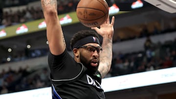 Anthony Davis, power forward for the Dallas Mavericks, performs a dunk against the Houston Rockets.
