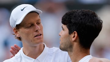Tennis - Wimbledon - All England Lawn Tennis and Croquet Club, London, Britain - July 13, 2025 Italy's Jannik Sinner with Spain's Carlos Alcaraz after winning the men's singles final REUTERS/Stephanie Lecocq