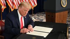 US President Donald Trump signs executive orders extending coronavirus economic relief, during a news conference in Bedminster, New Jersey, on August 8, 2020. (Photo by JIM WATSON / AFP)