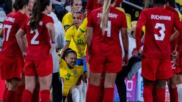 Brazil's Kathellen Sousa Feitoza (bottom C) is helped up by the team's medical staff during the 2023 SheBelieves Cup women's soccer match between Canada and Brazil at Geodis Park in Nashville, Tennessee, on February 19, 2023. (Photo by SETH HERALD / AFP)