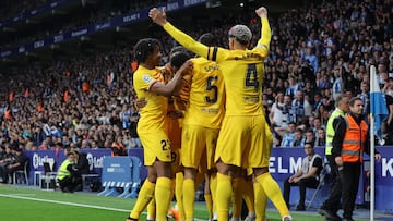 Barcelona's players celebrate their opening goal scored by Polish forward Robert Lewandowski during the Spanish league football match between RCD Espanyol and FC Barcelona at�the RCDE Stadium in Cornella de Llobregat on May 14, 2023. (Photo by Lluis GENE / AFP)