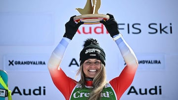 First-placed Switzerland's Corinne Suter lifts her trophy on the podium after winning the women's downhill race, part of the FIS Alpine Ski World Cup 2025-2026 in Soldeu, Andorra on February 26, 2026. (Photo by Lionel BONAVENTURE / AFP)