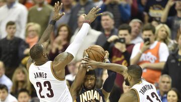 Apr 2, 2017; Cleveland, OH, USA; Cleveland Cavaliers forward LeBron James (23) and center Tristan Thompson (13) defend against Indiana Pacers forward Paul George (13) in the fourth quarter at Quicken Loans Arena. Mandatory Credit: David Richard-USA TODAY Sports