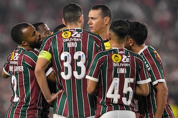 Colombian referee Wilmar Roldan (3-R) argues with players of Fluminense during the Copa Libertadores group stage second leg football match