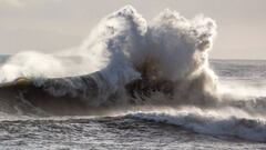 Una contraola choca con una ola en Sandpit (California, Estados Unidos) el 6 de enero del 2023, con dos surfistas mir&aacute;ndoselo desde el agua. 