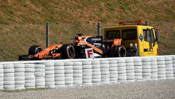 A truck carries the car of McLaren's Spanish driver Fernando Alonso during the first practice session at the Circuit de Catalunya on May 12, 2017 in Montmelo on the outskirts of Barcelona ahead of the Spanish Formula One Grand Prix. / AFP PHOTO / Josep LAGO