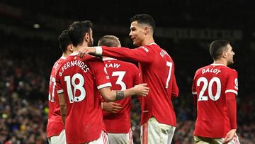 MANCHESTER, ENGLAND - FEBRUARY 15: Bruno Fernandes celebrates with Cristiano Ronaldo of Manchester United after scoring their team's first goal during the Premier League match between Manchester United and Brighton & Hove Albion at Old Trafford o