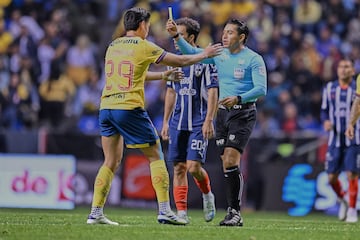   Referee Victor Alfonso Caceres shows yellow card to Ramon Juarez of Americaduring the final first-leg match between America and Monterrey  as part of the Torneo Apertura 2024 Liga MX at Cuauhtemoc Stadium, on December 12, 2024 in Puebla, Mexico.