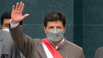 Peruvian President Pedro Castillo waves as he leaves the Congress building in Lima on March 28, 2022, after a brief statement in the chamber where he vowed his right to be represented by a lawyer during a discussion for possible impeachment. - If Peru's opposition-dominated congress votes to impeach leftist President Pedro Castillo, Vice-President Dina Boluarte will assume the position. (Photo by Cris BOURONCLE / AFP) (Photo by CRIS BOURONCLE/AFP via Getty Images)