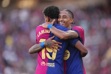 BARCELONA, SPAIN - AUGUST 31: Raphinha of FC Barcelona celebrates scoring his team's fifth goal with team mate Lamine Yamal of FC Barcelona during the La Liga match between FC Barcelona and Real Valladolid CF at Camp Nou on August 31, 2024 in Barcelona, Spain. (Photo by Alex Caparros/Getty Images)