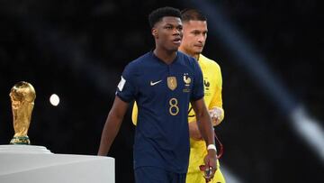 France's midfielder #08 Aurelien Tchouameni and France's goalkeeper #23 Alphonse Areola walk past the trophy after receiving their silver medals during the Qatar 2022 World Cup trophy ceremony after losing the football final match between Argentina and France at Lusail Stadium in Lusail, north of Doha on December 18, 2022. - Argentina won in the penalty shoot-out. (Photo by FRANCK FIFE / AFP) (Photo by FRANCK FIFE/AFP via Getty Images)