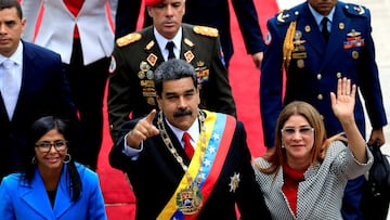 FILE PHOTO: Venezuela's President Nicolas Maduro, flanked by his wife Cilia Flores and National Constituent Assembly President Delcy Rodriguez, arrives for a special session of the National Constituent Assembly to take oath as re-elected President at the Palacio Federal Legislativo in Caracas, Venezuela May 24, 2018. REUTERS/Marco Bello TPX IMAGES OF THE DAY/File Photo