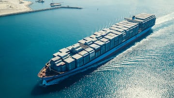 Dubai, United Arab Emirates - October 17, 2014: Aerial view of a cargo container ship leaving the harbor