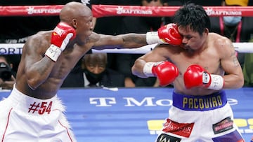 LAS VEGAS, NEVADA - AUGUST 21: Yordenis Ugas (L) hits Manny Pacquiao in the sixth round of their WBA welterweight title fight at T-Mobile Arena on August 21, 2021 in Las Vegas, Nevada. Ugas retained his title by unanimous decision.   Ethan Miller/Getty Im