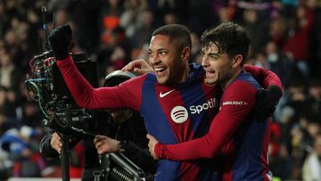 Barcelona's Brazilian forward #19 Vitor Roque (L) celebrates scoring the opening goal, with Barcelona's Spanish midfielder #08 Pedri, during the Spanish league football match between FC Barcelona and CA Osasuna at the Estadi Olimpic Lluis Companys in Barcelona on January 31, 2024. (Photo by LLUIS GENE / AFP)