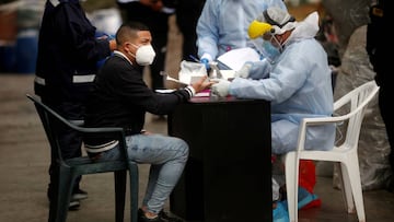 A man is being tested for the coronavirus disease (COVID-19) after he was detained when police raided a nightclub for hosting a party in violation of COVID-19 restrictions and where people were crushed to death or asphyxiated when they were trying to escape when the police arrived, in Lima, Peru August 23, 2020. REUTERS/Sebastian Castaneda NO RESALES. NO ARCHIVES