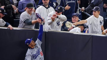 NEW YORK, NEW YORK - OCTOBER 29: Fans interfere with Mookie Betts #50 of the Los Angeles Dodgers as he attempts to catch a fly ball in foul territory during the first inning of Game Four of the 2024 World Series against the New York Yankees at Yankee Stadium on October 29, 2024 in the Bronx borough of New York City. The play resulted in an out. Al Bello/Getty Images/AFP (Photo by AL BELLO / GETTY IMAGES NORTH AMERICA / Getty Images via AFP)