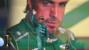 Aston Martin's Spanish driver Fernando Alonso waves to fans from the podium after the 2023 Formula One Australian Grand Prix at the Albert Park Circuit in Melbourne on April 2, 2023. (Photo by Paul CROCK / AFP) / -- IMAGE RESTRICTED TO EDITORIAL USE - STRICTLY NO COMMERCIAL USE --