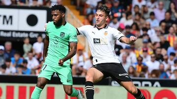 Atletico Madrid's French midfielder #11 Thomas Lemar vies with Valencia's Spanish forward #9 Hugo Duro during the Spanish Liga football match between Valencia CF and Club Atletico de Madrid at the Mestalla stadium in Valencia on September 16, 2023. (Photo by Jose Jordan / AFP)