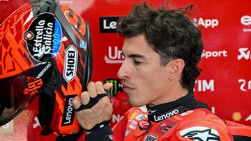 Ducati Lenovo Team's Spanish MotoGP rider Marc Marquez puts on his helmet as he prepares for the free practice ahead of the MotoGP Indonesian Grand Prix at the Mandalika International Circuit in Mandalika, West Nusa Tenggara on October 3, 2025. (Photo by SONNY TUMBELAKA / AFP)