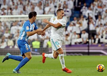 Real Madrid's Lucas Vázquez tussles for the ball with Málaga's Diego González.