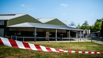 This general view shows barrier tape cordoning off buildings of a mink farm at Beek en Donk, eastern Netherlands on April 26, 2020, after tests showed that animals within had been infected with the new coronavirus (COVID-19). - Dutch authorities cordoned 