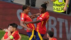 Spain's Lamine Yamal, top left celebrates with Spain's Nico Williams, top right and other team mates after Dani Olmo scored the opening goal during a quarter final match between Germany and Spain at the Euro 2024 soccer tournament in Stuttgart, Germany, Friday, July 5, 2024. (AP Photo/Michael Probst)