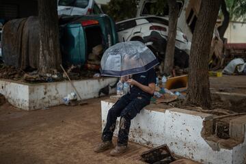 Un hombre se protege de la lluvia con un paraguas, en Benetússer, Valencia.