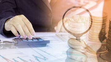 double exposure of business woman analyzing on financial graph report and stock chart, hand holding magnifying glass with graph,calculator and stack of coins