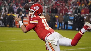 Kansas City Chiefs quarterback Patrick Mahomes (15) throws a pass while being tackled