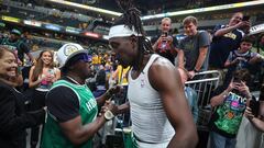 INDIANAPOLIS, INDIANA - MAY 25: Jrue Holiday #4 of the Boston Celtics hugs Flava Flav after defeating the Indiana Pacers in Game Three of the Eastern Conference Finals at Gainbridge Fieldhouse on May 25, 2024 in Indianapolis, Indiana. NOTE TO USER: User expressly acknowledges and agrees that, by downloading and or using this photograph, User is consenting to the terms and conditions of the Getty Images License Agreement.   Stacy Revere/Getty Images/AFP (Photo by Stacy Revere / GETTY IMAGES NORTH AMERICA / Getty Images via AFP)